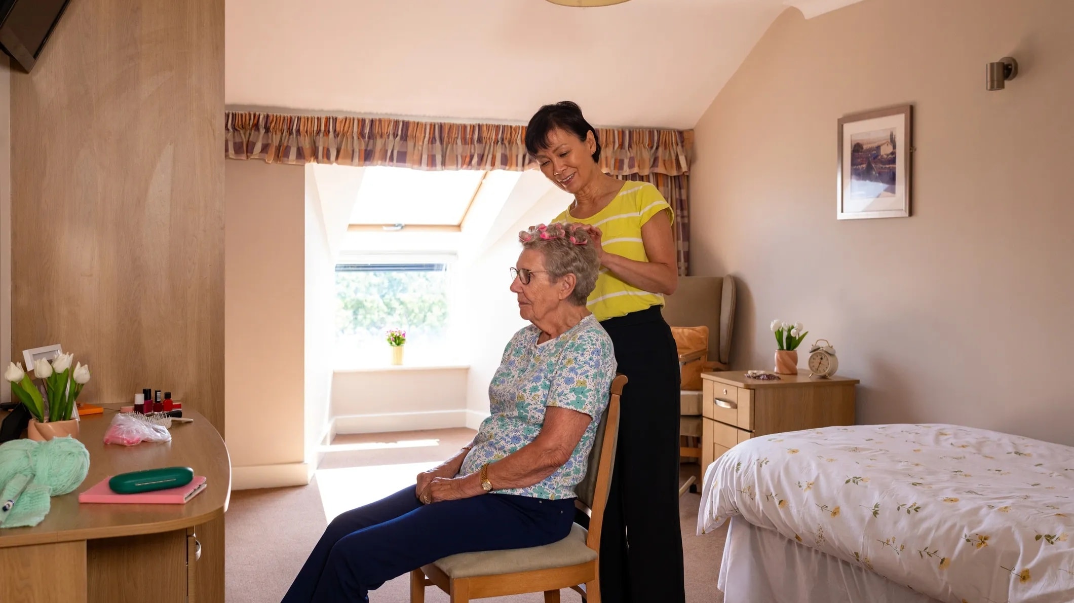 Caregiver sharing a warm moment with an elderly client at home