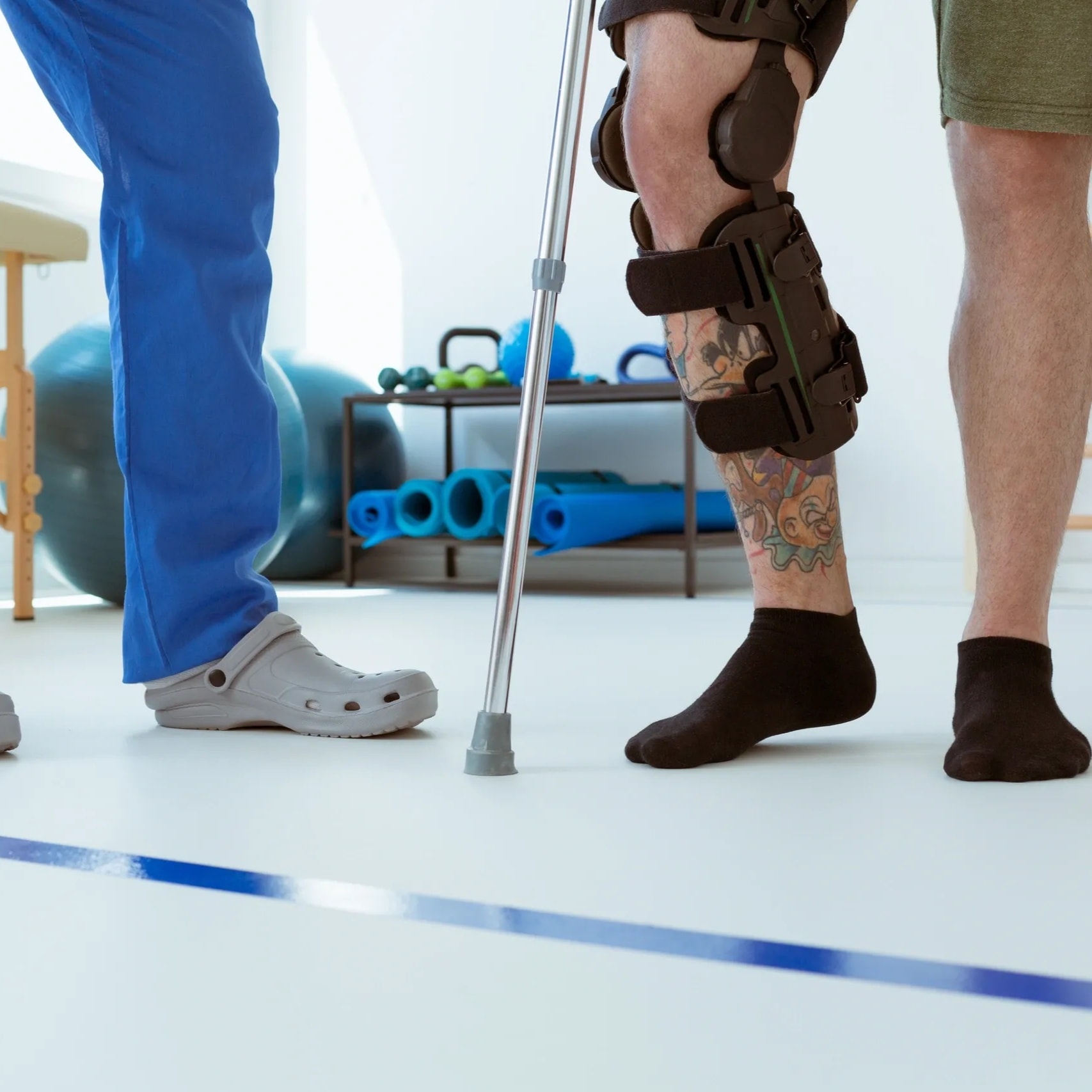 Adult comfortably recovering at home with warm non-medical caregiver support — both people visible